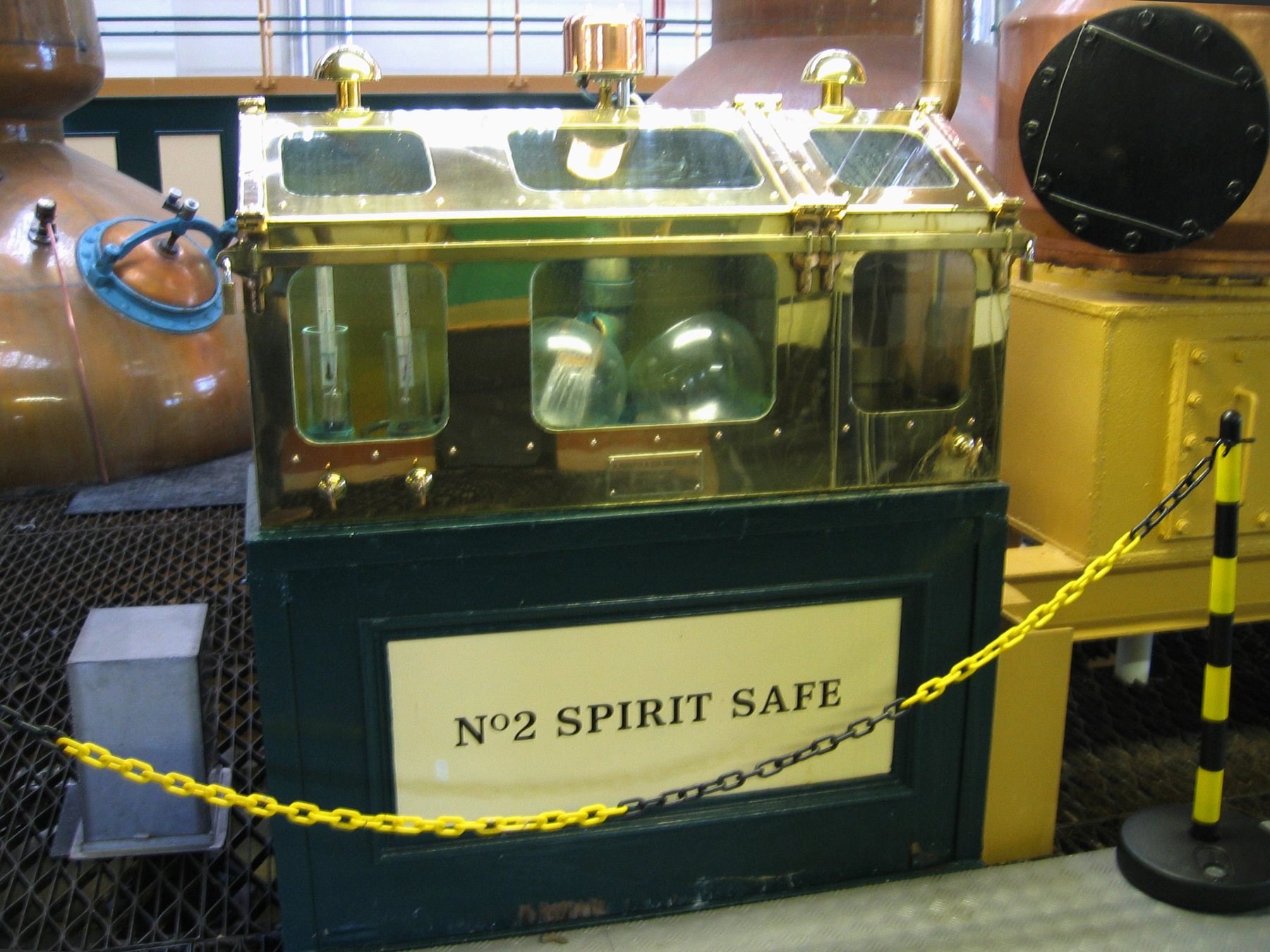 No. 2 Spirit Safe at The Glenlivet with copper distillation equipment behind it