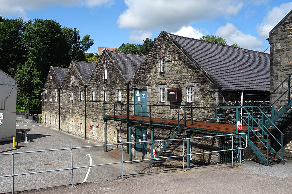 Stone bonded warehouses at Strathmill Distillery in Keith, Moray, viewed from the distillery access yard.